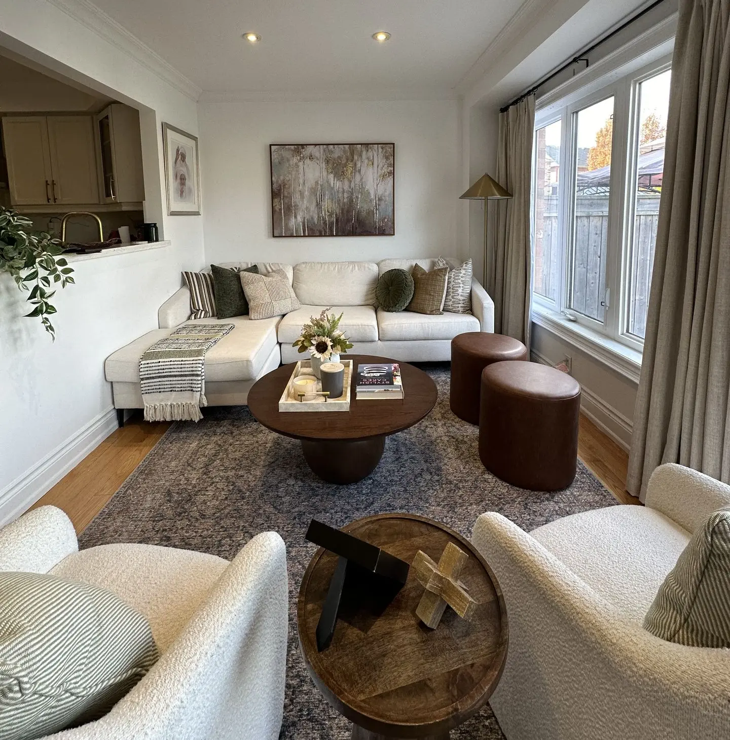 Cozy living room with white sofa, leather ottomans and warm tones